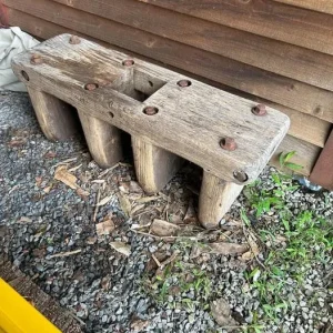 wooden-bench-with-a-hole-in-the-middle-the-bolts-go-all-the-way-through-the-legs-and-it-is-very-heavy.-found-in-the-basement-of-an-old-farm-house